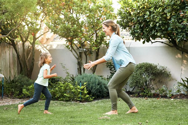 Mother and Daughter Playing in Pest-Free Yard