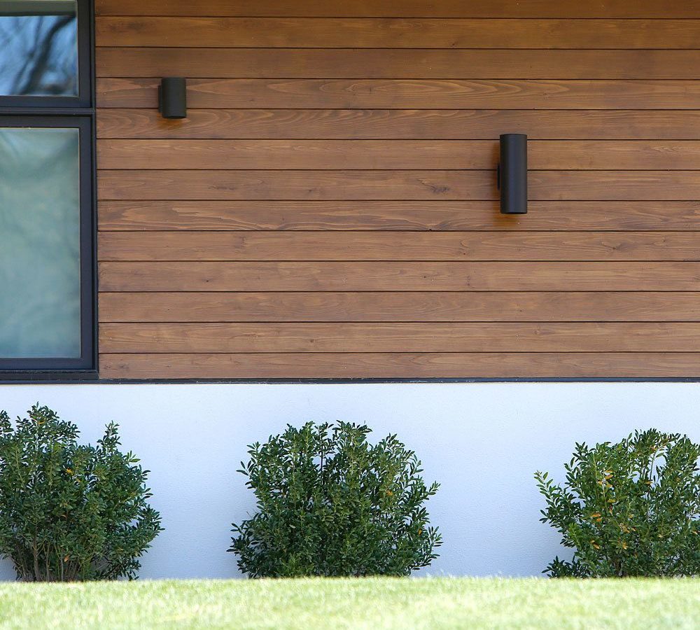 The side of a house with bushes