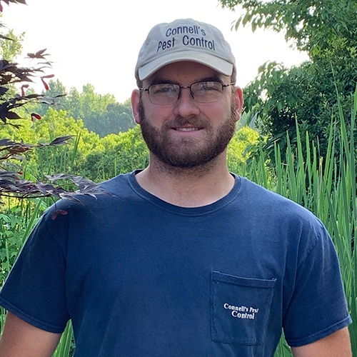 a man standing in front of a tree